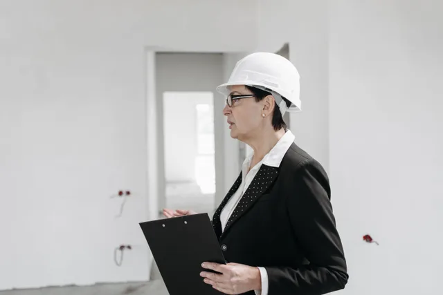 Professional female engineer inspecting a construction site with clipboard and helmet. Ghost kitchen compliance checklist: the operating cadence
